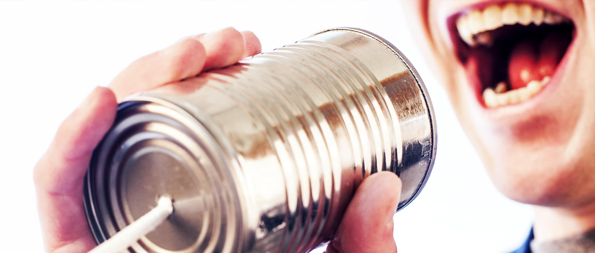 Someone yelling into a tin can telephone