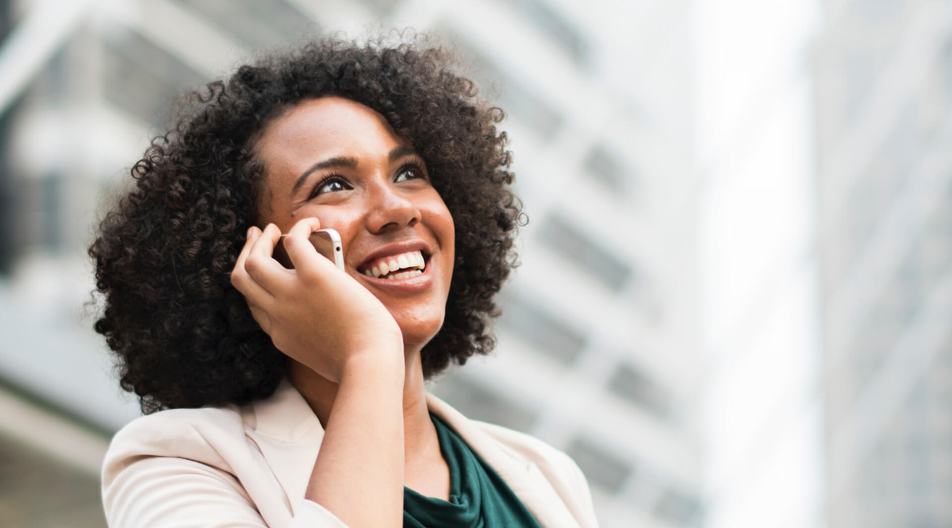 Businesswoman smiling and talking on a cell phone