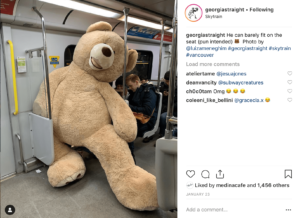 A photo taken on the skytrain of a giant teddy bear that takes up two seats.