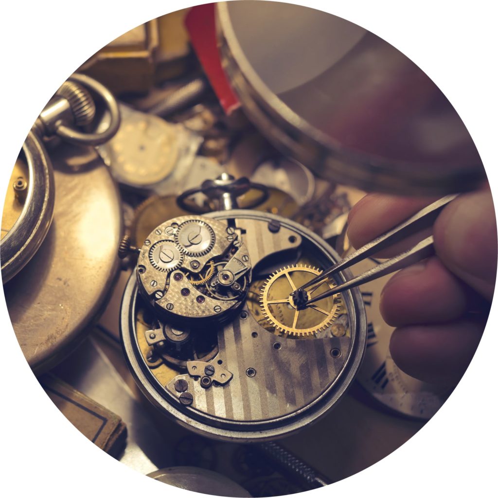 Close-up of someone building a watch by hand