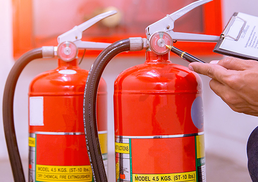 Person inspecting fire extinguishers.